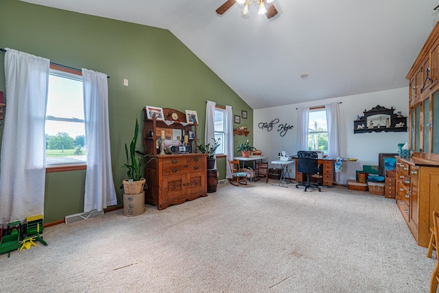 carpeted office with vaulted ceiling and ceiling fan