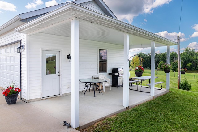 view of patio with a garage and grilling area