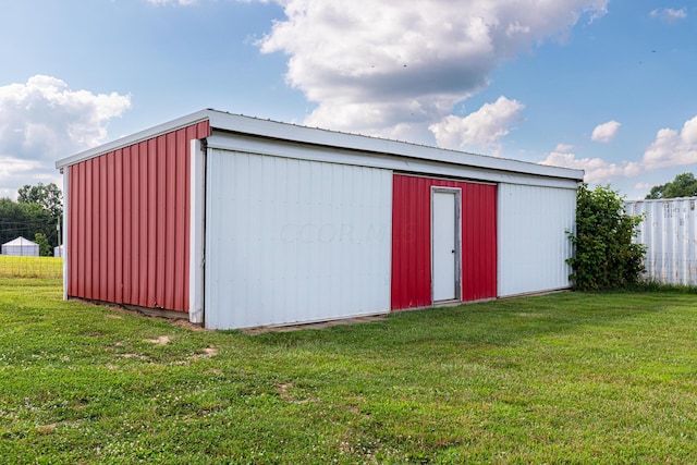 view of outbuilding featuring a yard