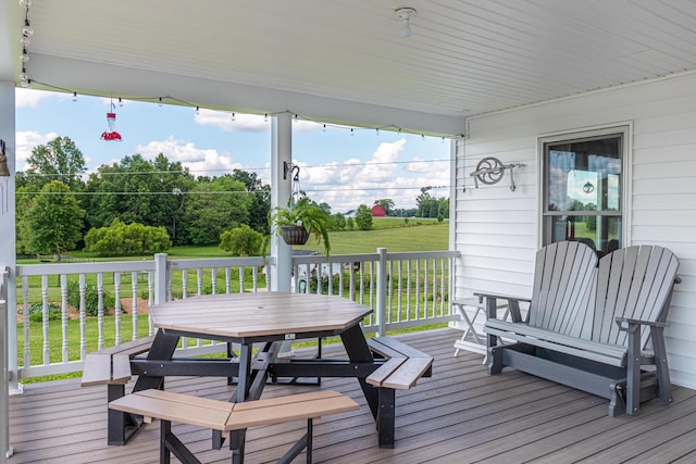 wooden deck with a lawn