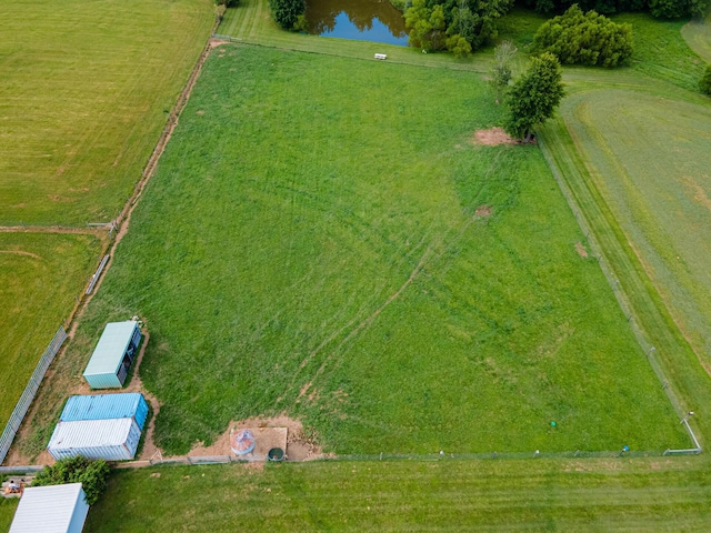 birds eye view of property with a water view and a rural view