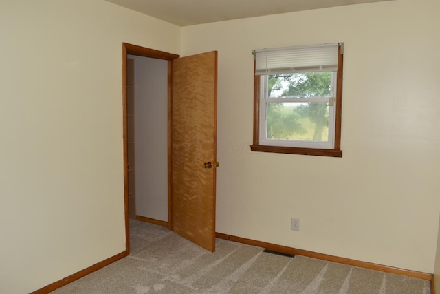 empty room featuring light carpet