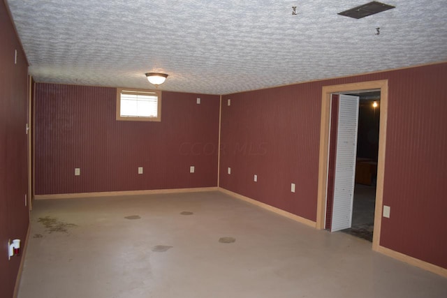 basement featuring a textured ceiling