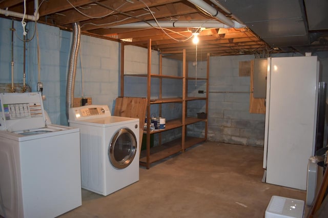 basement with separate washer and dryer and white fridge