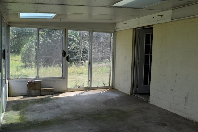 unfurnished sunroom featuring a skylight