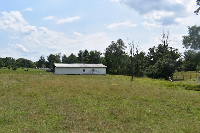 view of yard featuring an outbuilding and a rural view