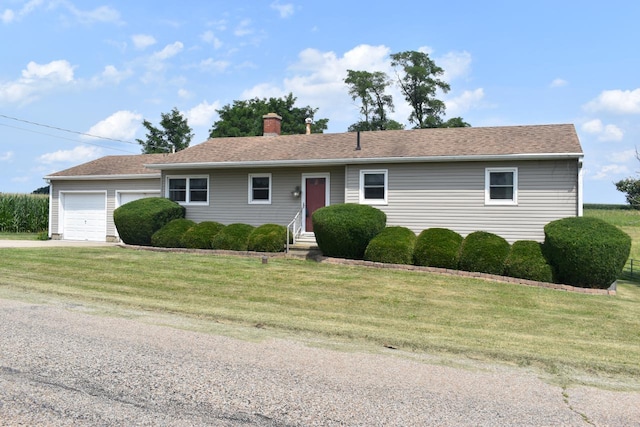 single story home featuring a front yard and a garage