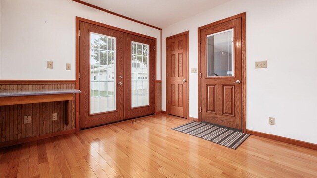 doorway to outside featuring french doors and light hardwood / wood-style flooring