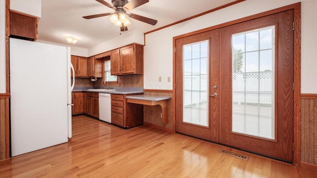 kitchen featuring ceiling fan, french doors, sink, light hardwood / wood-style flooring, and white appliances