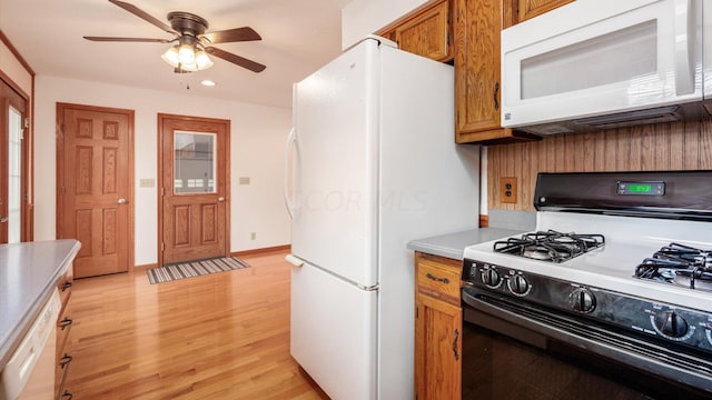 kitchen featuring white appliances, light hardwood / wood-style floors, and ceiling fan