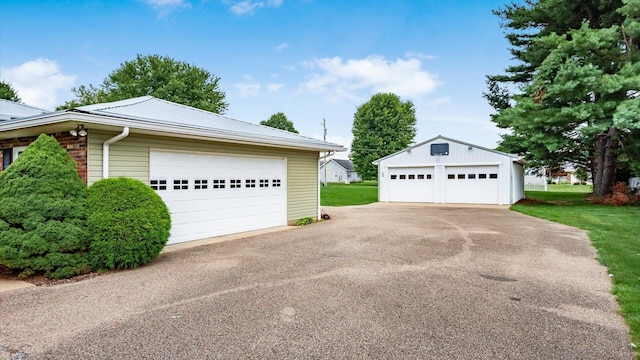 view of side of home featuring an outbuilding and a garage