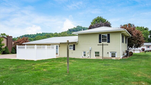 rear view of house with a lawn