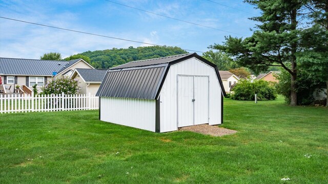 view of outbuilding featuring a lawn