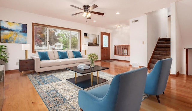 living room featuring wood-type flooring and ceiling fan