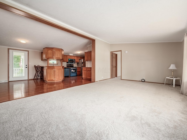 unfurnished living room with a textured ceiling, crown molding, dark wood-type flooring, and lofted ceiling