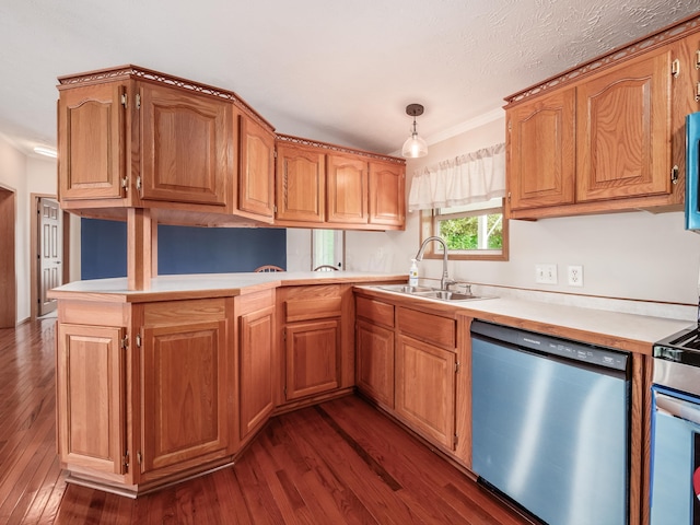 kitchen featuring dark wood-type flooring, sink, decorative light fixtures, kitchen peninsula, and stainless steel appliances