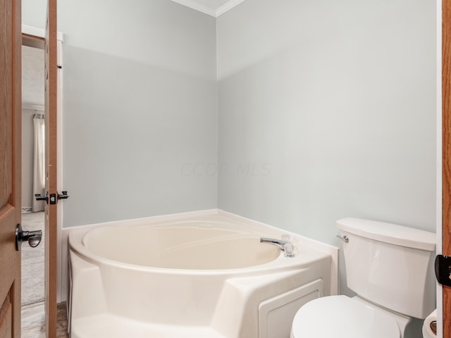 bathroom with ornamental molding, toilet, and a bathing tub