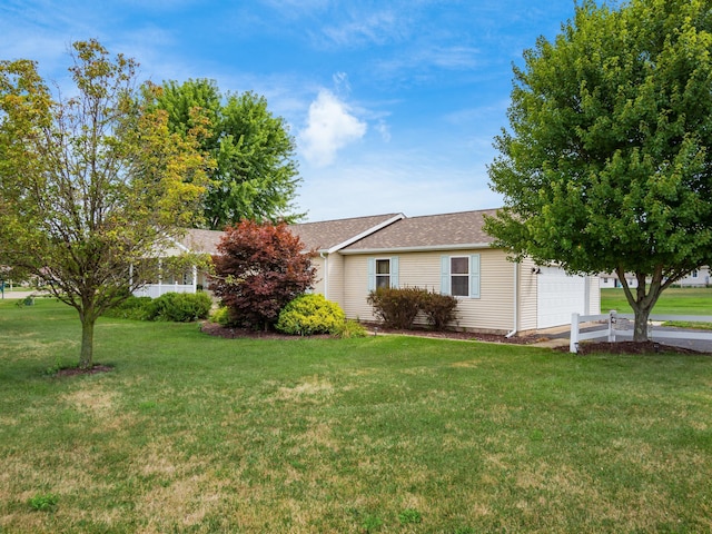 exterior space with a garage and a front lawn