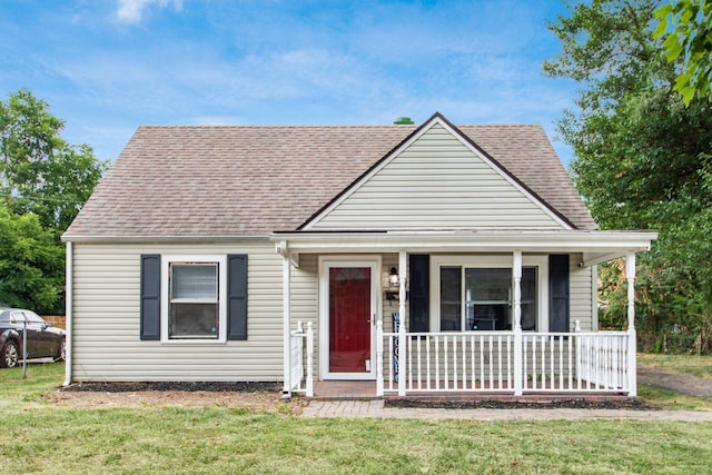 view of front of property with a porch and a front lawn