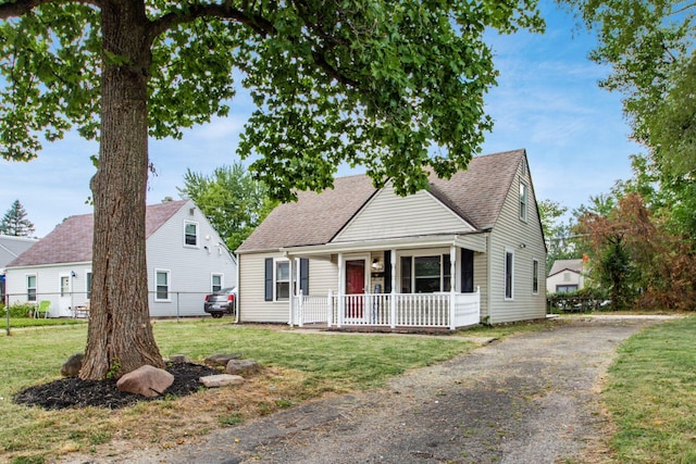 view of front of home featuring covered porch and a front lawn