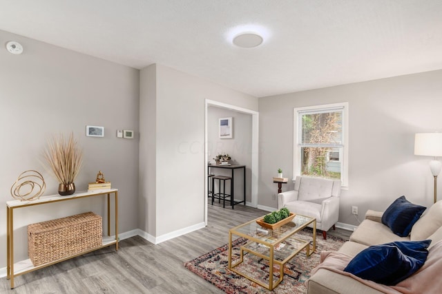 living room featuring a textured ceiling and light hardwood / wood-style floors