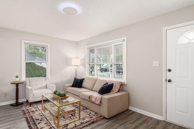 living room with hardwood / wood-style floors and a textured ceiling