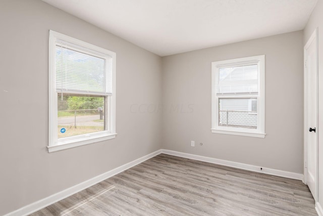 unfurnished room with light hardwood / wood-style flooring