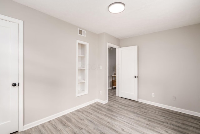 spare room with light wood-type flooring