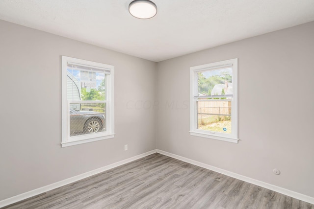 empty room with a healthy amount of sunlight and light wood-type flooring