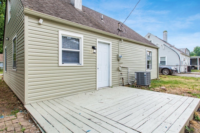 back of house featuring central AC unit and a wooden deck