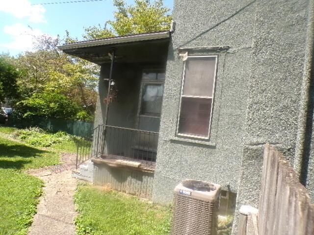 view of side of home with central AC unit