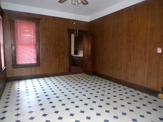 2343 Indianola Ave, Columbus, OH 43202 - unfurnished room featuring wood walls, ceiling fan, and light floors