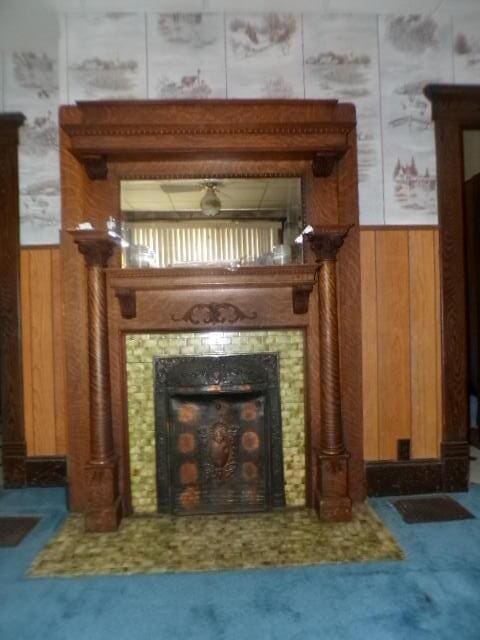 2343 Indianola Ave, Columbus, OH 43202 - detailed view of wood walls, a tiled fireplace, carpet floors, a ceiling fan, and wainscoting