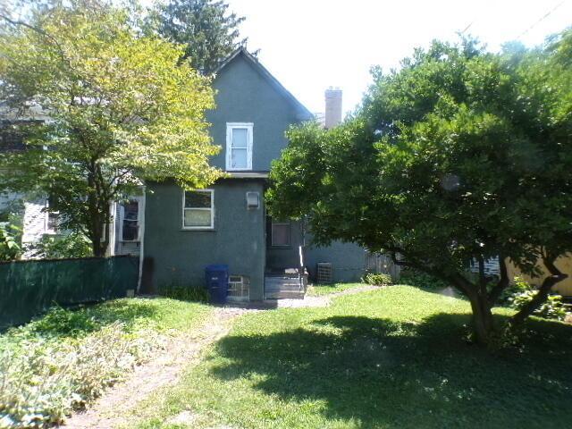 2343 Indianola Ave, Columbus, OH 43202 - back of property featuring stucco siding, a yard, and a chimney