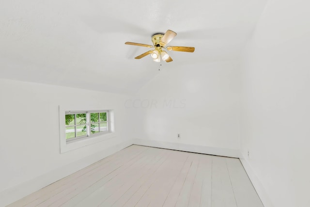 empty room with vaulted ceiling, light hardwood / wood-style flooring, and ceiling fan