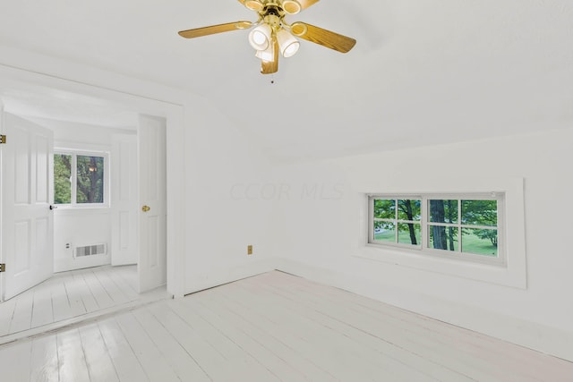 unfurnished room with ceiling fan, light hardwood / wood-style floors, and vaulted ceiling