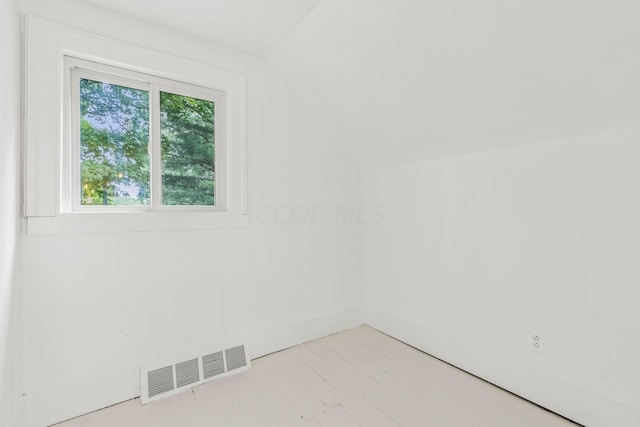 empty room with lofted ceiling