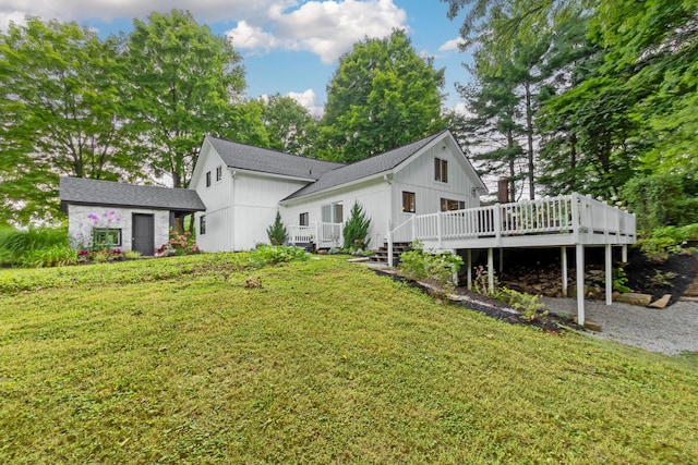 rear view of property with a yard and a deck