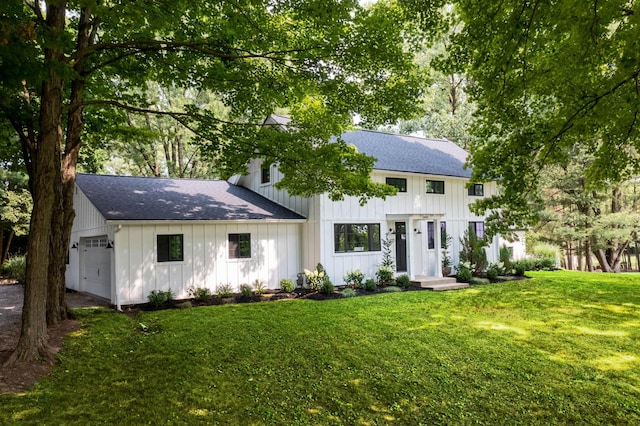 view of front of house featuring a garage and a front lawn