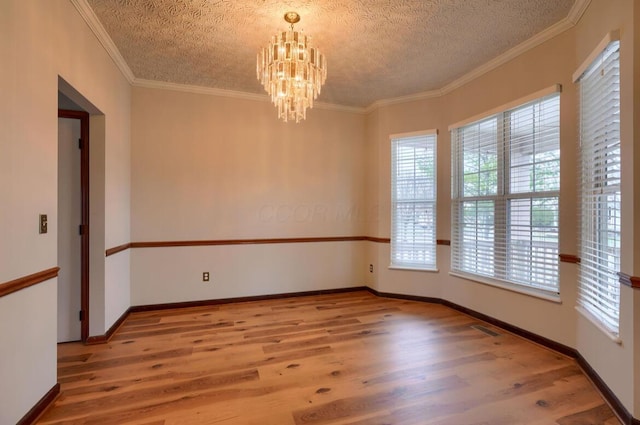 7265 Bromfield Dr, Canal Winchester, OH 43110 - empty room with wood finished floors, a chandelier, a textured ceiling, and crown molding
