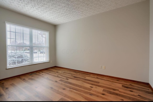 7265 Bromfield Dr, Canal Winchester, OH 43110 - empty room with wood finished floors and a textured ceiling