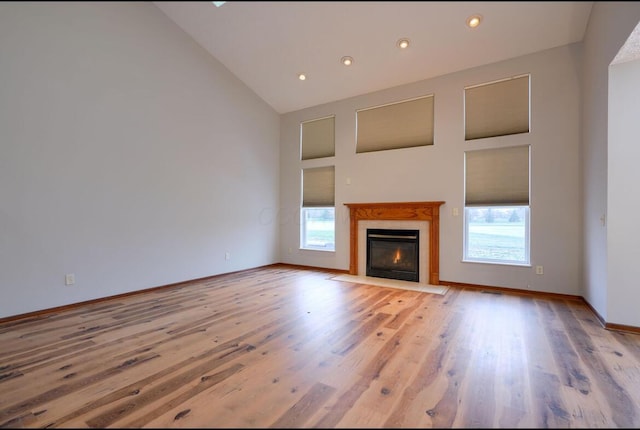 7265 Bromfield Dr, Canal Winchester, OH 43110 - unfurnished living room with high vaulted ceiling, light wood finished floors, a tile fireplace, and recessed lighting