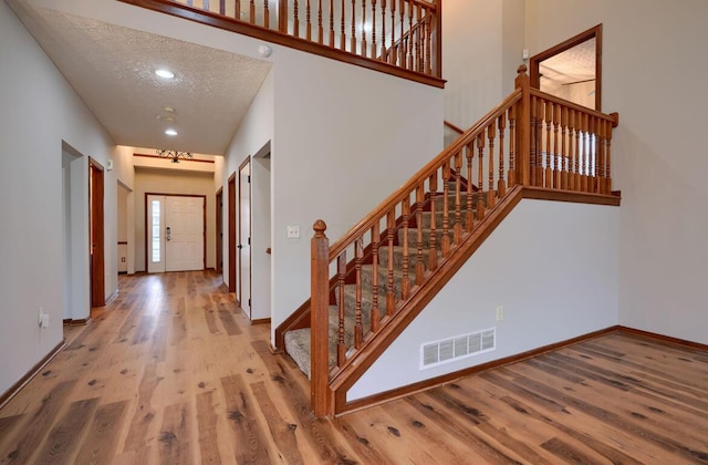 7265 Bromfield Dr, Canal Winchester, OH 43110 - stairs with wood finished floors and a textured ceiling