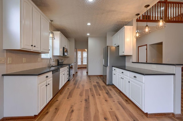 7265 Bromfield Dr, Canal Winchester, OH 43110 - kitchen featuring appliances with stainless steel finishes, dark countertops, white cabinetry, a textured ceiling, and recessed lighting