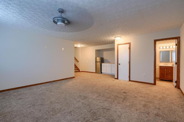 7265 Bromfield Dr, Canal Winchester, OH 43110 - unfurnished room featuring light carpet, a textured ceiling, and stairs