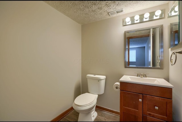 7265 Bromfield Dr, Canal Winchester, OH 43110 - half bath with wood finished floors, vanity, and a textured ceiling