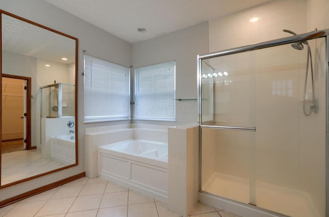 7265 Bromfield Dr, Canal Winchester, OH 43110 - full bathroom featuring a garden tub, a shower stall, tile patterned floors, and a spacious closet