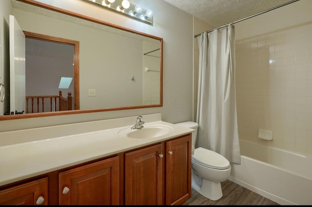 7265 Bromfield Dr, Canal Winchester, OH 43110 - full bathroom featuring vanity, shower / tub combo with curtain, wood finished floors, and a textured ceiling