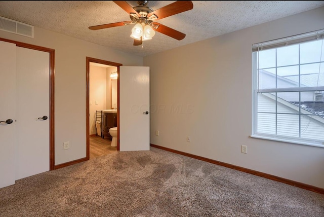 7265 Bromfield Dr, Canal Winchester, OH 43110 - unfurnished bedroom featuring carpet flooring, a textured ceiling, connected bathroom, and ceiling fan