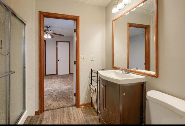 7265 Bromfield Dr, Canal Winchester, OH 43110 - full bath featuring vanity, wood finished floors, a ceiling fan, a shower with shower door, and a textured ceiling